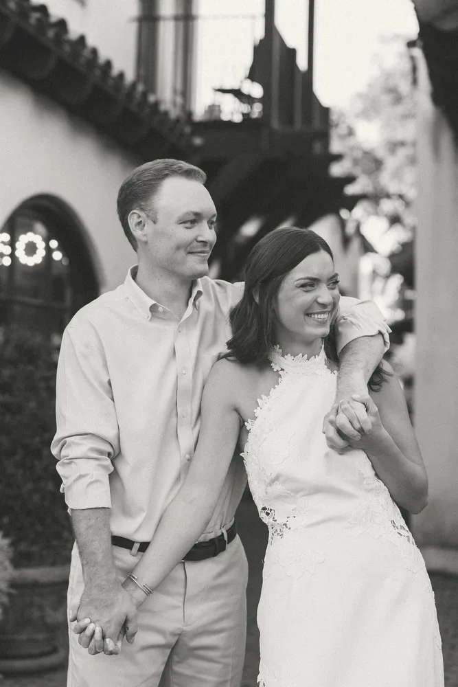 A black-and-white portrait of Alexandra and Dalton laughing together